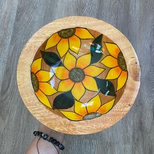 Vintage handcrafted wooden bowl with sunflowers .